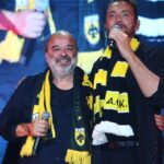 Χρήστος Μενιδιάτης με κιτρινόμαυρο κασκόλ στην πίστα